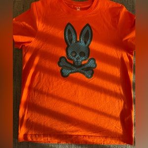 Bright orange Psycho Bunny shirt with blue basketball bunny.